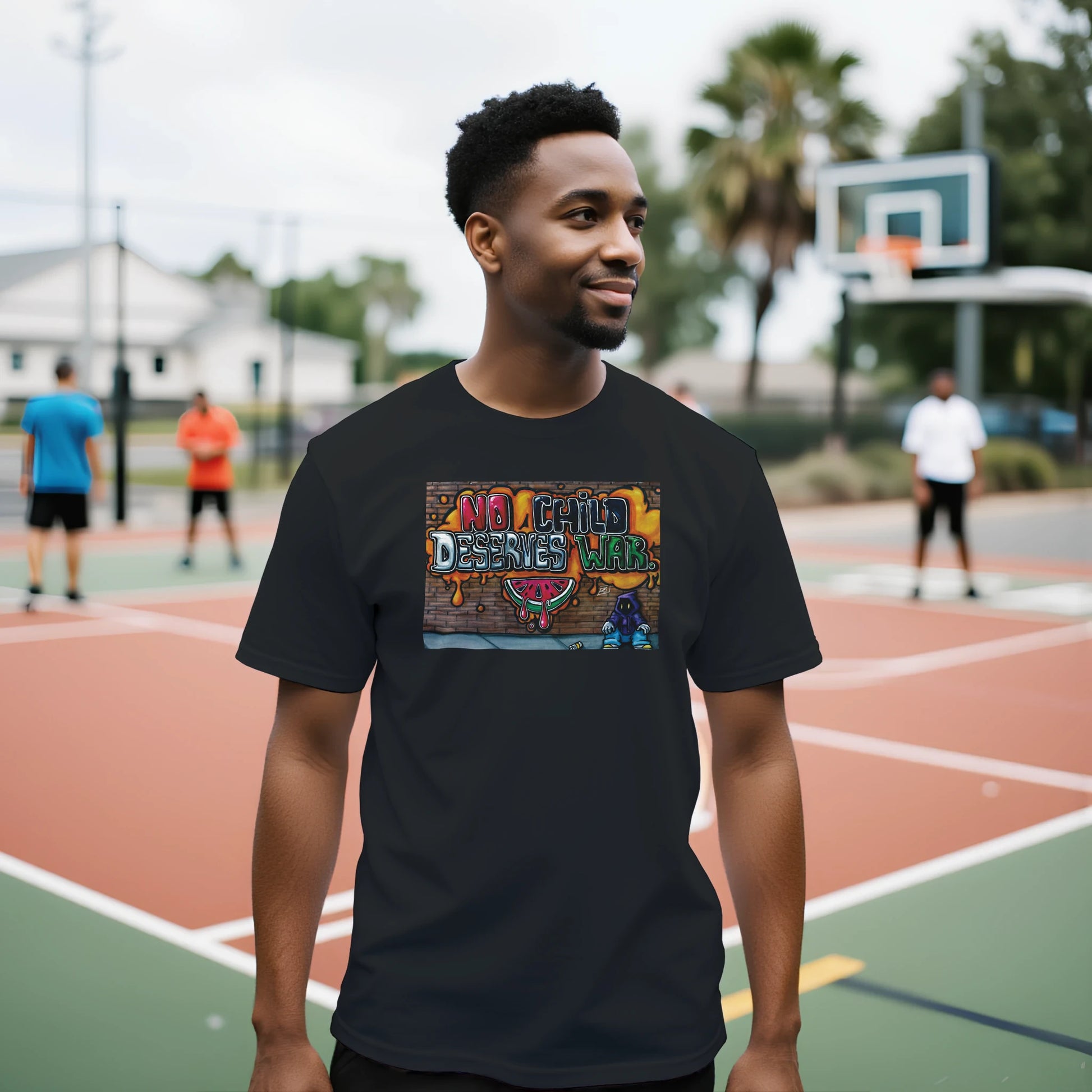 Man wearing a black t-shirt with colorful graphic design on a basketball court